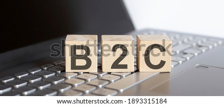 B2C abbreviation stands for written on wooden cube on laptop