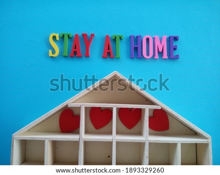 word STAY AT HOME on blue background