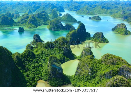 Aerial view floating fishing village and rock island, Halong Bay, Vietnam, Southeast Asia. UNESCO World Heritage Site. Junk boat cruise to Ha Long Bay. Popular landmark, famous destination of Vietnam Royalty-Free Stock Photo #1893339619