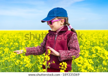 girl in a yellow field of rape.