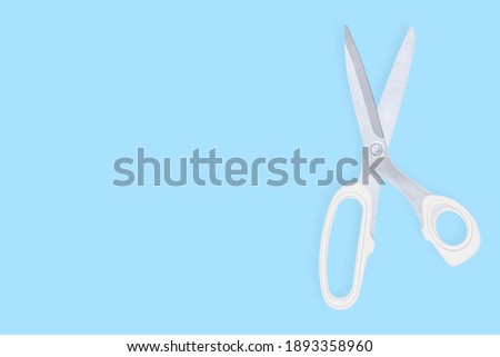 Scissors seamless pattern. Barber scissors against blue background backdrop