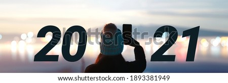2021 new year concept. Rear view of adult travel people relax in nature and city bokeh on mist mountain blur blackground banner size.