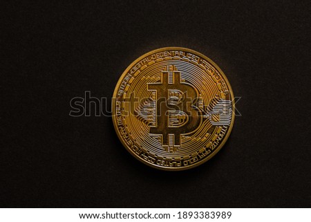 single golden shiny valuable bitcoin front view with black middle view