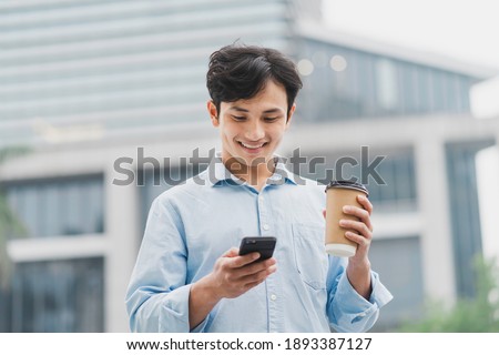 Asian business man standing in coffee and using cell phone

 Royalty-Free Stock Photo #1893387127