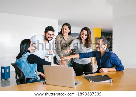 Group of latin business people working together as a teamwork while sitting at the office desk in a creative office in Mexico city Royalty-Free Stock Photo #1893387535