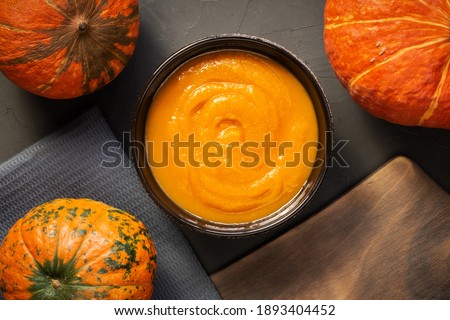 Vegetable healthy diet food, cooking food recipe for pumpkin soup mashed potatoes, caviar, with fresh orange fruits on the kitchen table