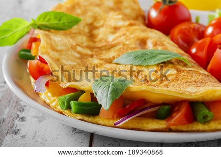 omelet with vegetables and cherry tomatoes  Royalty-Free Stock Photo #189340868