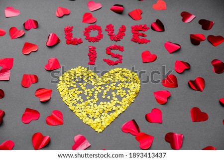 Love is a yellow heart on a gray background on Valentine's Day.