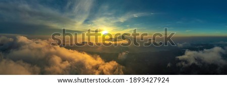 Panoramic picture of a colorful cloudy sunrise in mount batur, bali, indonesia 