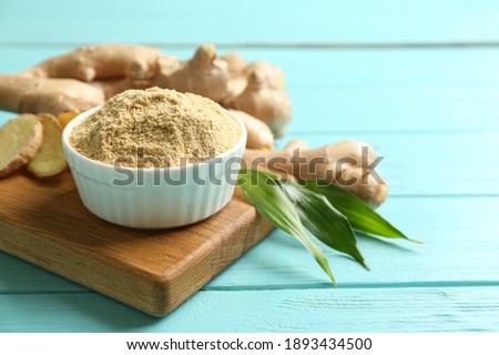 Dry and fresh ginger on light blue wooden table