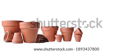 group of terra cotta flower pots empty in panoramic view  on white background Royalty-Free Stock Photo #1893437800