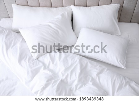 Comfortable bed with soft white pillows, closeup Royalty-Free Stock Photo #1893439348