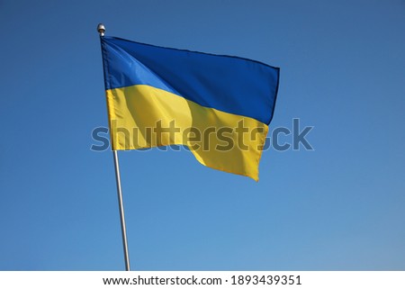 National flag of Ukraine against blue sky Royalty-Free Stock Photo #1893439351
