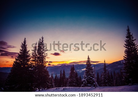Beautiful dawn in the winter snow-covered mountains and amazingly beautiful clouds. High quality photo