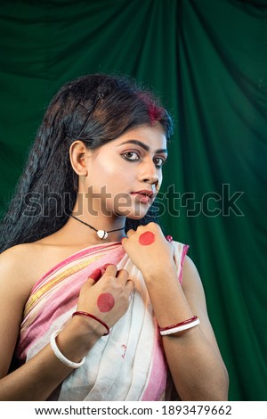 Portrait of   black haired Indian brunette woman with opening her eyes  and posing