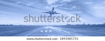 White Passenger plane fly up over take-off runway from airport  Royalty-Free Stock Photo #1893485755