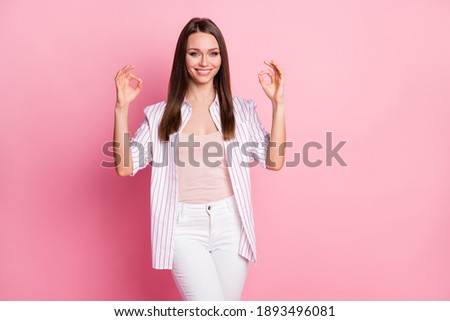 Photo of young beautiful smiling attractive woman girl hold hands showing ok sign isolated on pink color background