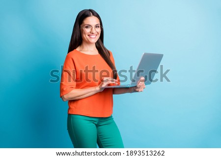 Portrait of attractive lady arms hold computer eyewear toothy smile isolated on blue color background