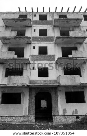 Black and white abandoned block of flats under construction. Brick and cement textures -  details 