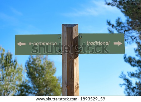 A selective focus shot of a way signpost with "E-commerce" and "Traditional" writings