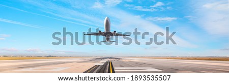 White Passenger plane fly up over take-off runway from airport  Royalty-Free Stock Photo #1893535507