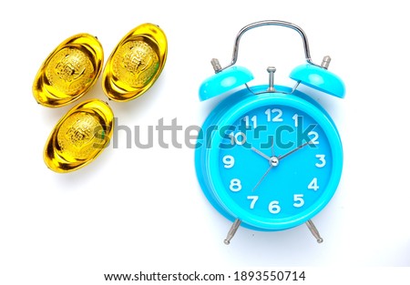 A picture of three golden ingot or "yuan bao" with written word prosperity in Chinese and blue alarm clock.
