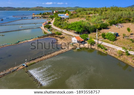 Aerial view of  white shrimp ( prawn ) farm with aerator pump in front of O Loan lagoon, Phu Yen, Vietnam.