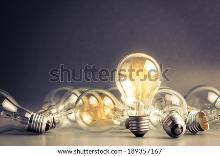 A light bulb that stable and glowing among the others Royalty-Free Stock Photo #189357167