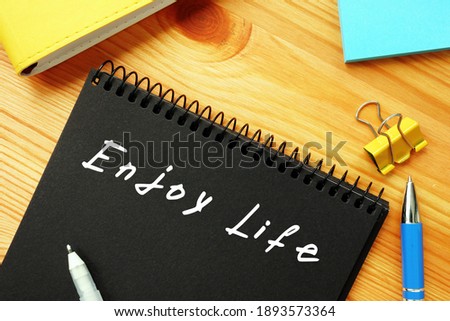 Business concept meaning Enjoy Life  with sign on the sheet.
