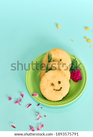 Smiling face cookies on the light blue background.