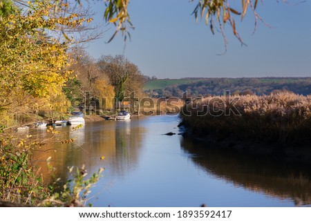 Walking along the river Arun on a Autumn afternoon, moored boats
