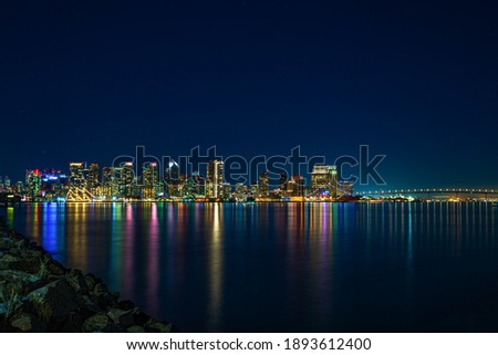 San Diego city lights reflecting off ocean.