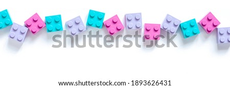 Colored toy bricks on white background	
