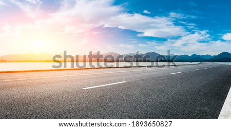 Asphalt road and mountain with sky clouds at sunset. Royalty-Free Stock Photo #1893650827