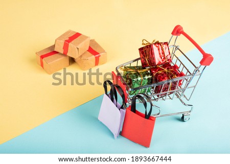 
A lot of colorful gifts box in a shopping cart