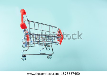 An empty miniature shopping cart