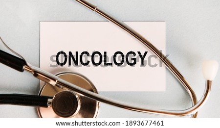 On the card text ONCOLOGY, near a stethoscope, medical concept.
