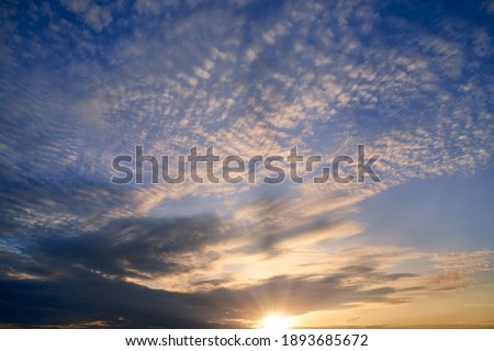 Sunrise skyline with blue sky and sun rays pass from cloud for new hope concept background