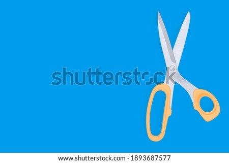 Scissors seamless pattern. Barber scissors against blue background backdrop