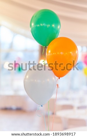 Three multi-colored balloons on holiday. Close-up balloons at an event.