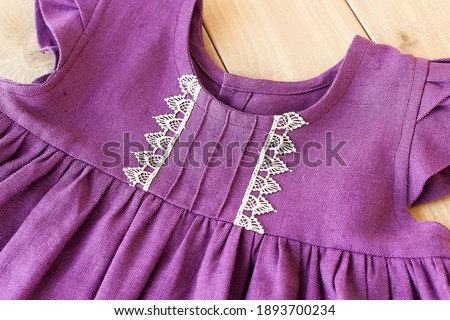 A light purple dress. Dress on an old wooden background.Sleeveless Party Dress.