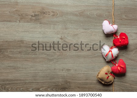 Handmaded hearts on wooden background. Valentine's day card.