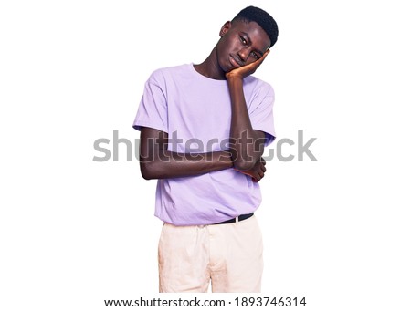 Young african american man wearing casual clothes thinking looking tired and bored with depression problems with crossed arms. 