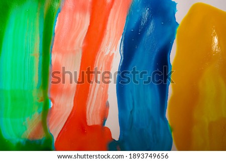 yellow, blue, red, green - Colors Painted  over white paper. colorful background. Smears of Rainbow Colored Paint Isolated on a White Background