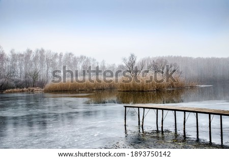 Landscape with frozen water, ice and fog on the river Seversky Donets Ukraine Cold foggy day