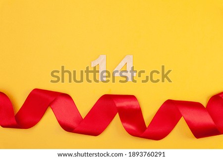 Beautiful red heart and curved ribbon on yellow background