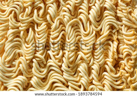 Macro instant raw noodle. Close-up uncooked ramen texture. Food background, top view 