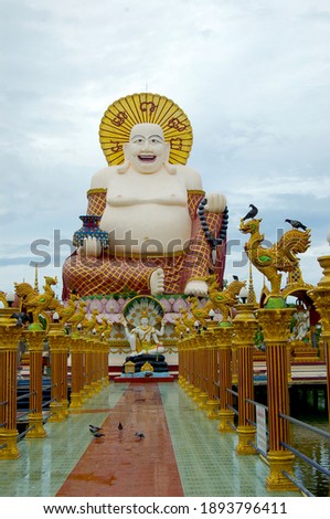  A picture of an eye-catching statue of the fat, laughing Chinese Buddha in Koh Samui, Thailand. 