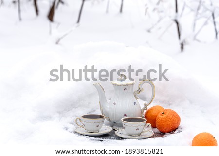Still life with a coffee set in a winter snowy forest.