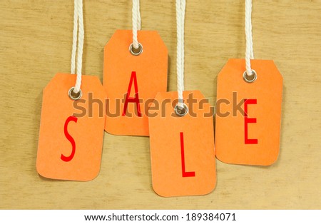 Sale Price tag hanging  with on wooden for background